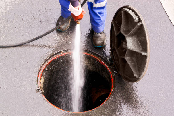 low section of man cleaning manhole